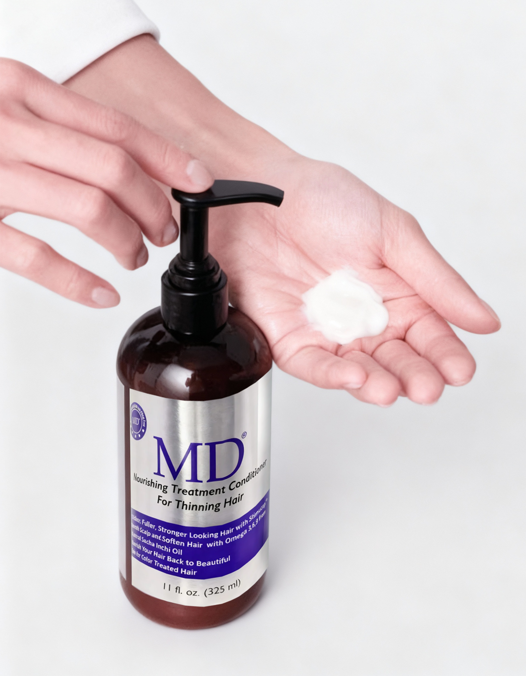 Applying MD® Revitalizing Treatment Conditioner. Weightless repair formula for thinning and damaged hair.