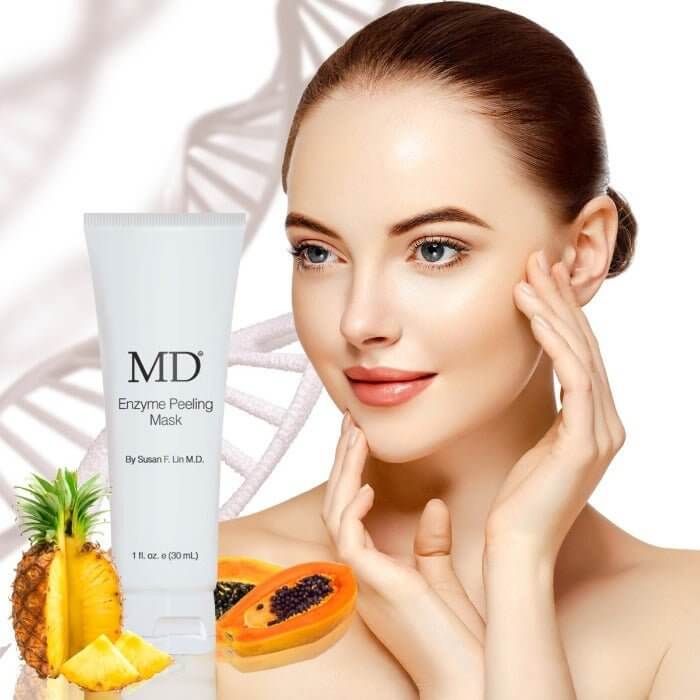 Model applying MD Enzyme Mask with papaya and pineapple enzymes for gentle exfoliation and skin brightening in the MD Skin collection

