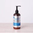 Lifestyle photo of MD® Revitalizing Treatment Conditioner – shown in an elegant bathroom setting, part of the MD Hair system for thinning hair and scalp hydration